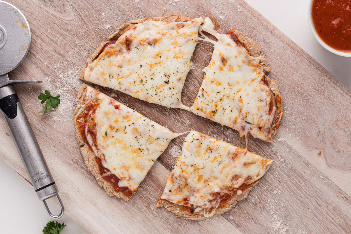 Small sliced pizza on a cutting board.