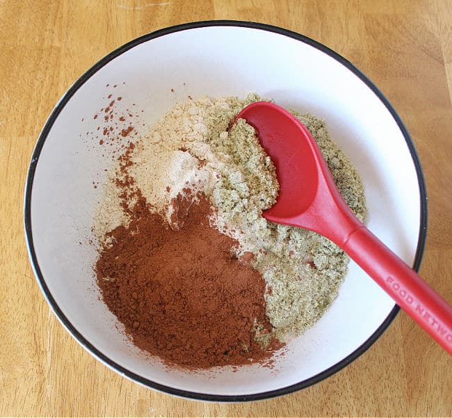 Flours and cocoa powder in a large white bowl.