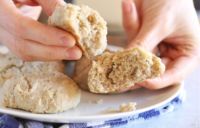 Hand holding two halves of a biscuit.