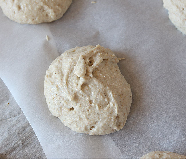 Unbaked biscuit on a piece of parchment paper.