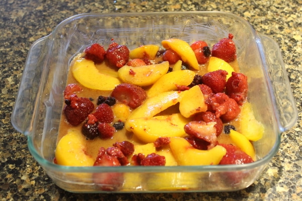 Peaches and berries in a baking dish.