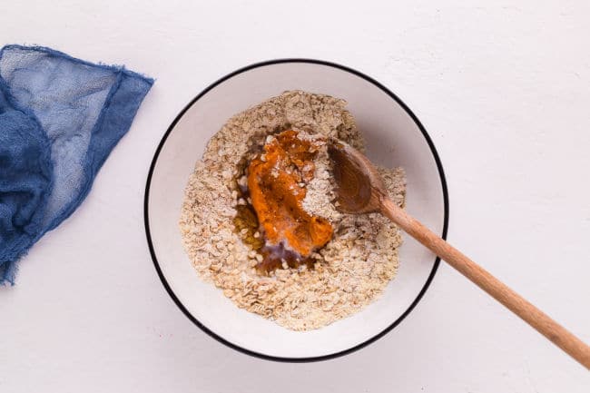 Flour, oats, sweet potato, and maple syrup in a bowl.
