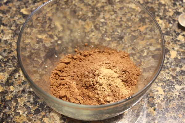 Cocoa and carob powders mixed in a bowl.