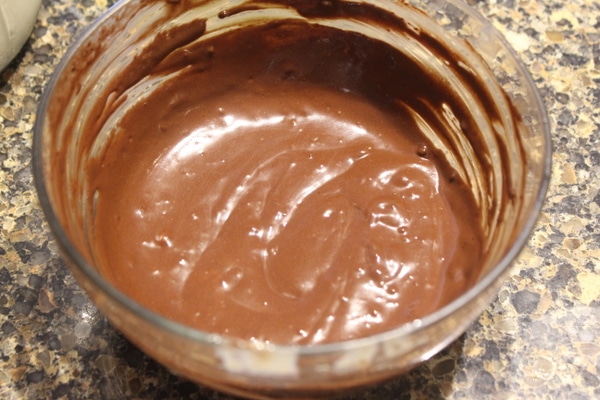 Carob chocolate sauce in a glass bowl.