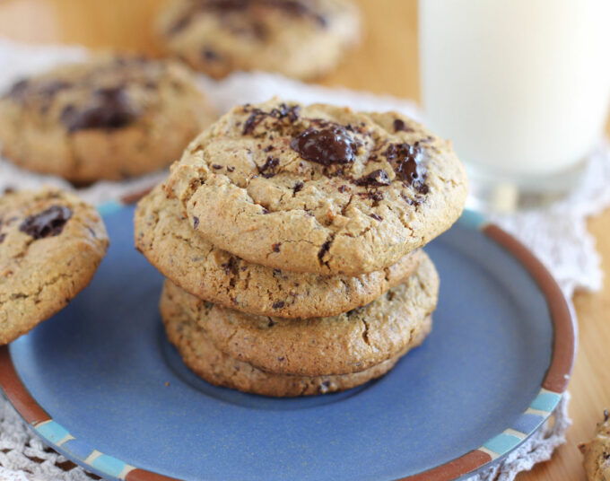 Stack of four chocolate chip cookies on a blue plate.