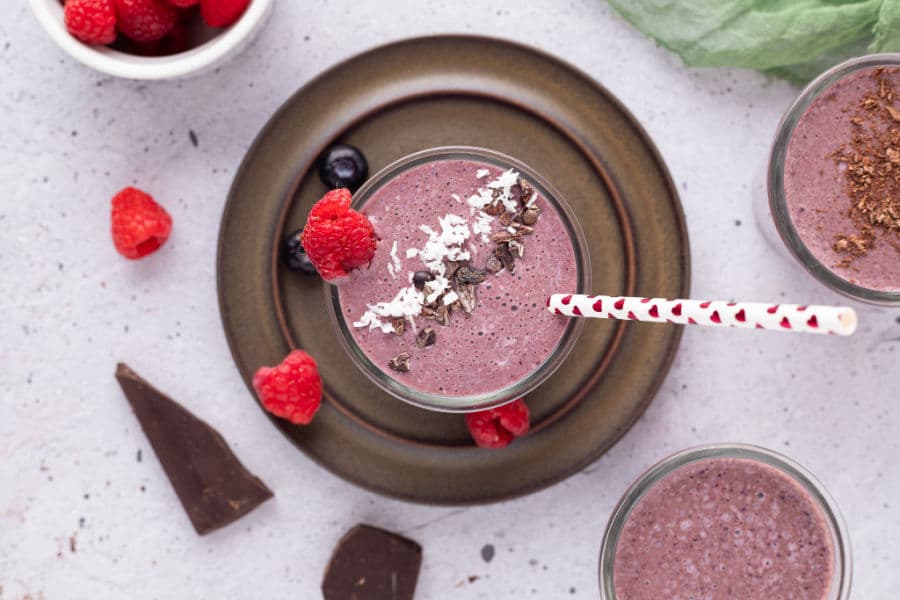Looking into a chocolate berry smoothie topped with cacao nibs and coconut.