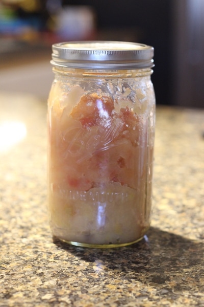 Mason jar filled with applesauce.