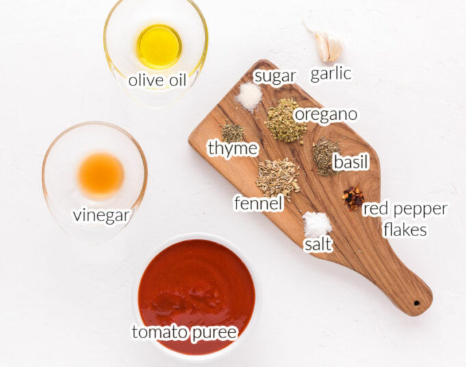 Garlic, spices, and tomato puree on a table.