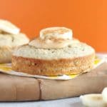 Cake with peanut butter and a banana on top with an orange background.