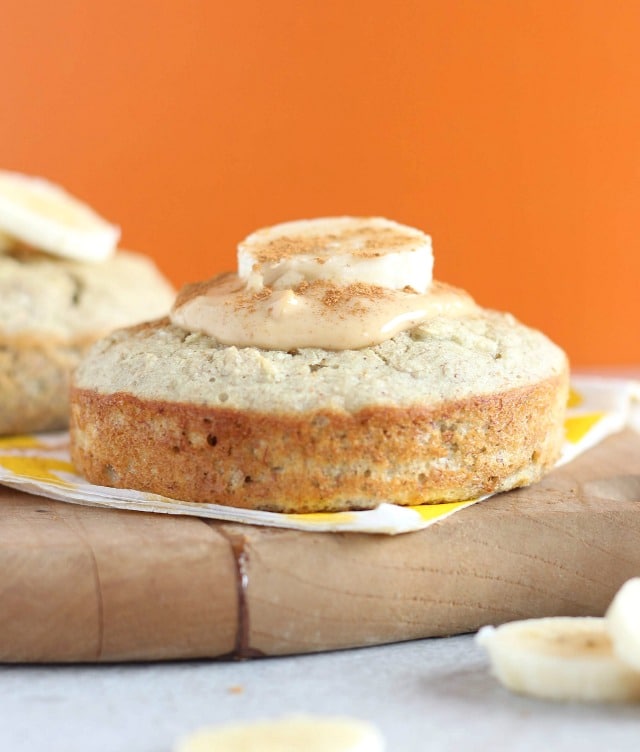 Cake with peanut butter and a banana on top with an orange background.