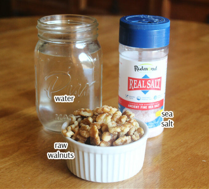 Walnuts, salt, and water on a table.