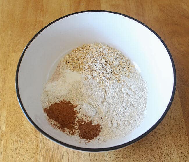 Flour, salt, and cinnamon in a large white bowl.