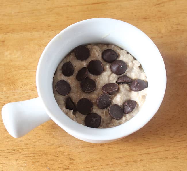 Batter with chocolate chips in a small white dish.