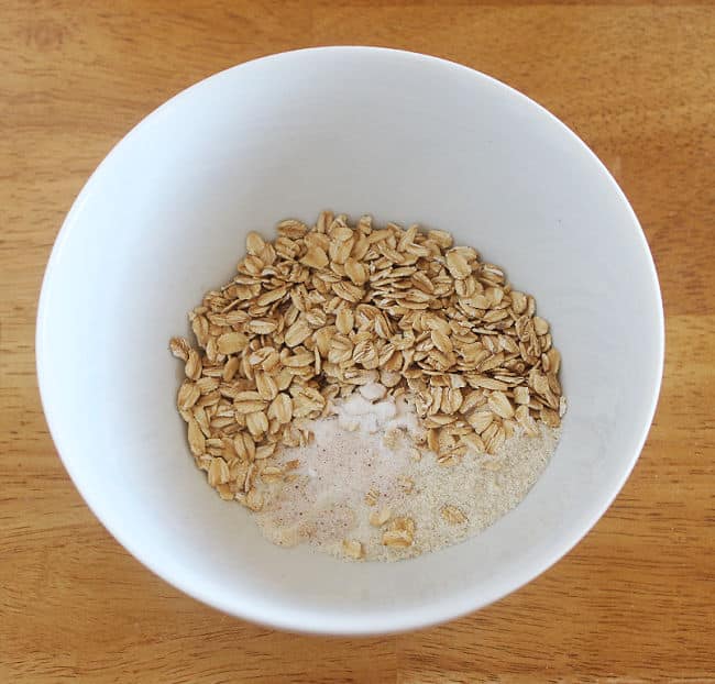 Oats and salt in a white bowl.