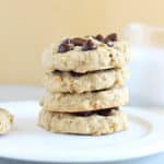 Stack of four cookies on a white plate.