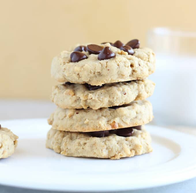 Stack of four cookies on a white plate.