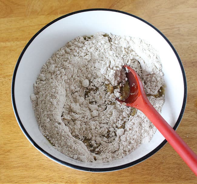 Flour, sugar, salt, and olive oil in a large white bowl.