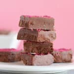 Stack of chocolate fudge with a pink background.