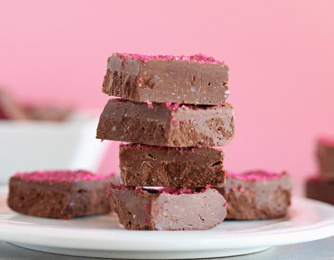 Stack of chocolate fudge with a pink background.