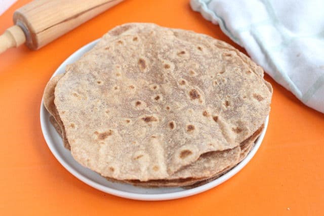 Stack of fresh spelt flour tortillas on a plate.