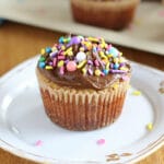 Healthy vanilla cupcakes with chocolate frosting on a white plate.