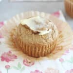 Muffin on a flower napkin with butter on top.