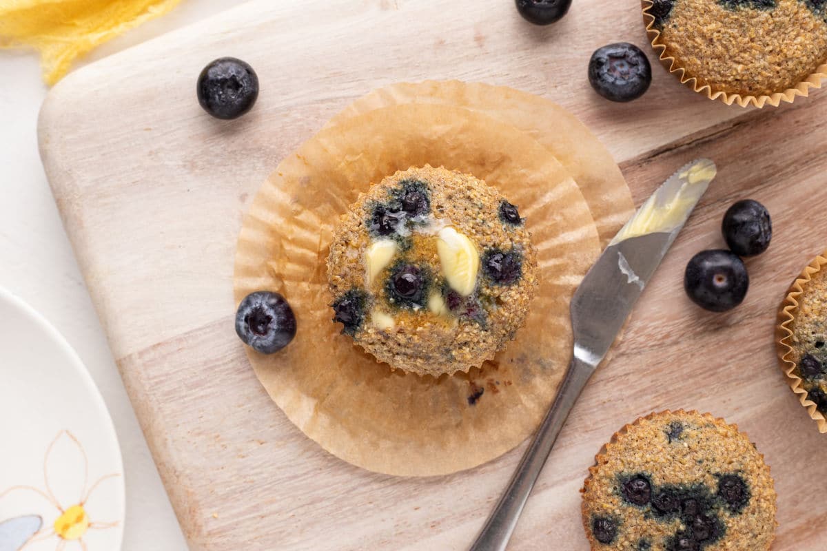 Top of blueberry muffin with butter.