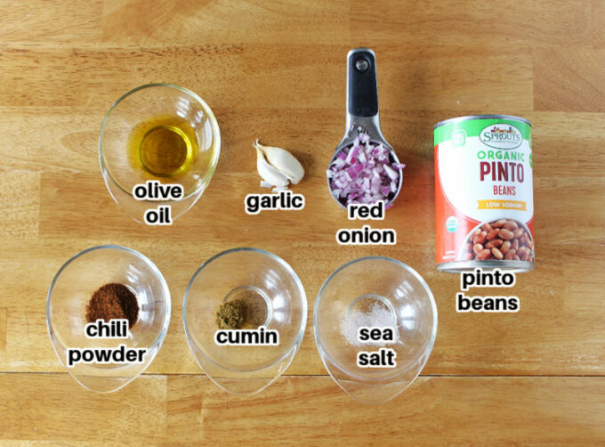 Various ingredients laid out on a table, including pinto beans and spices.