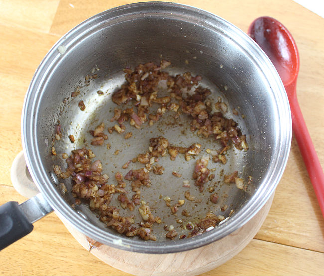 Sauteed onion and garlic in a steel pot.