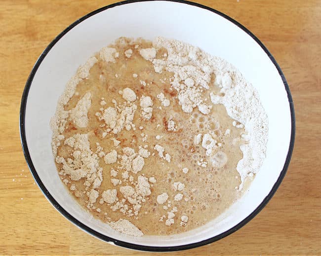 Unmixed muffin batter in a large white bowl.