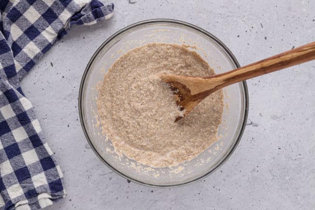 Stirring muffin batter with a wooden spoon.