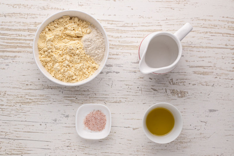 Flour, water, salt, and oil on a table.