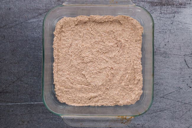 Batter spread into a glass baking dish.