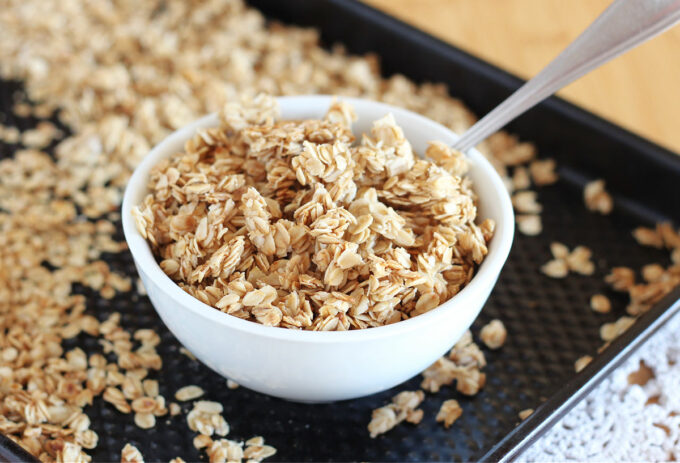 Bowl of granola on a baking sheet.