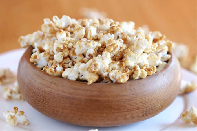 Close-up of homemade caramel corn in a brown bowl.