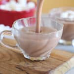 Hot chocolate being poured into a small glass.