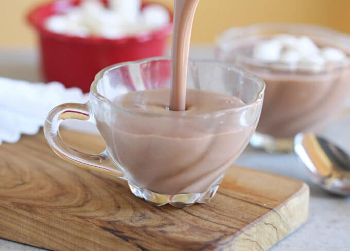 Hot chocolate being poured into a small glass.
