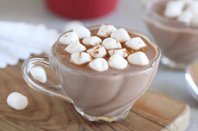 Hot chocolate in a glass mug with marshmallows.