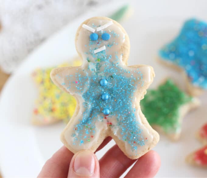 Gingerbread boy decorated with blue sprinkles.