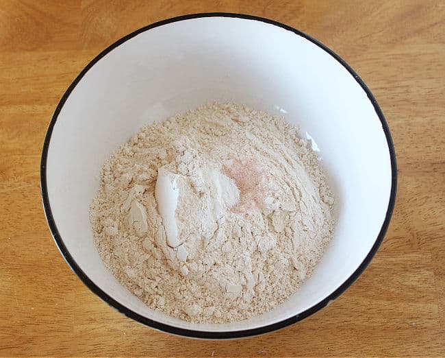 Flour and baking powder in a large white bowl.