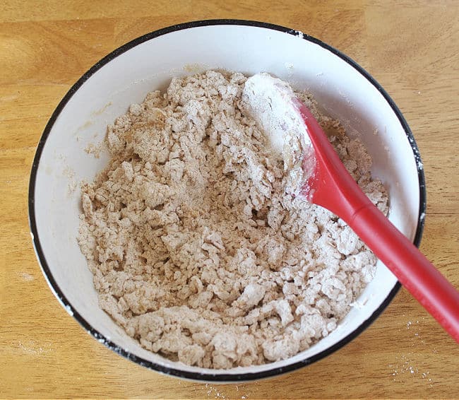 Pebbly-looking flour mixture in a white bowl.