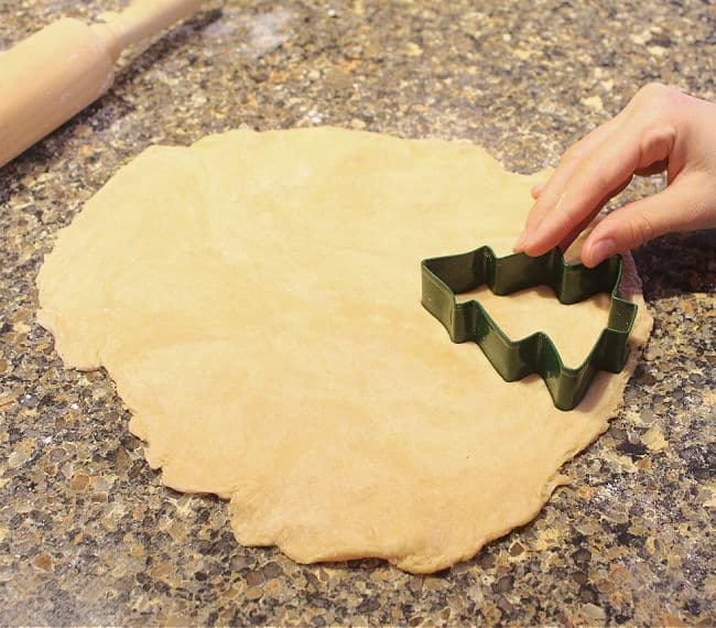 Christmas tree cookie cutter on rolled out dough.