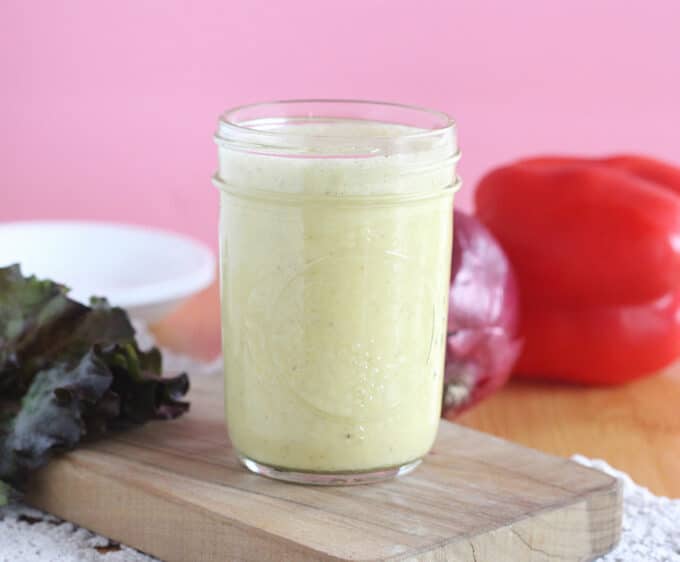 Creamy salad dressing in a small mason jar.