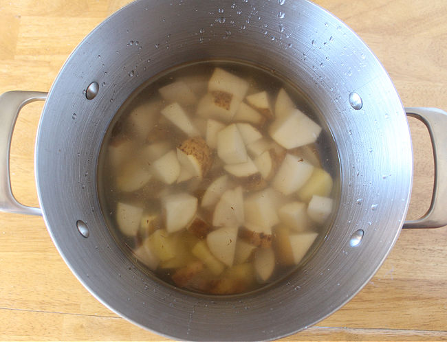Potatoes and water in a large pot.