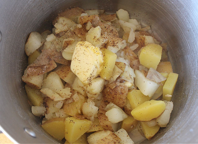 Potato cubes and butter in a pot.