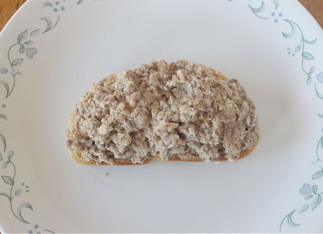 Slice of toast topped with sardines.