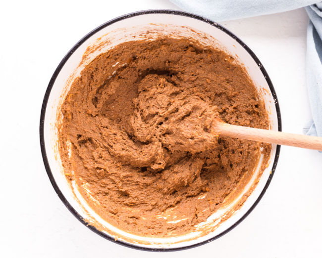 Brownie batter being stirred in a bowl.