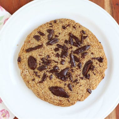 Single chocolate chip cookie on a plate.