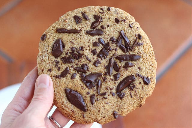 Gluten-free chocolate chip cookie in a hand.