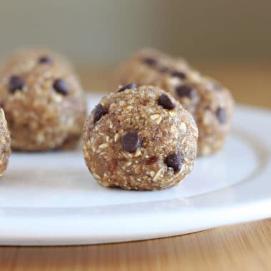Chocolate chip energy balls on a white plate.
